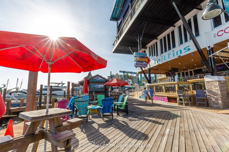 the sun shining on the Boardwalk at Tailfins restaurant