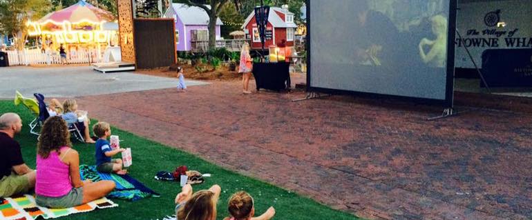 Kids watching a movie on the lawn at Baytowne Wharf