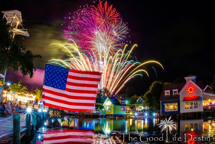 The Flag hanging in Baytowne Wharf with the fireworks exploding in background