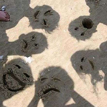 Drawing Faces in the Sand for a Creative Photo