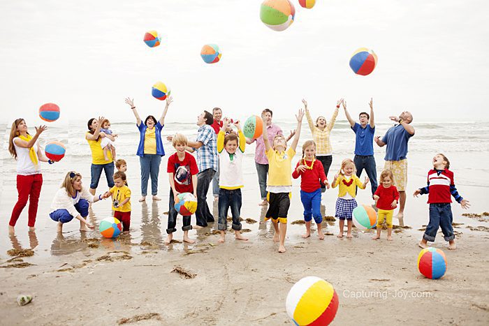 Family throwing beach balls in the air