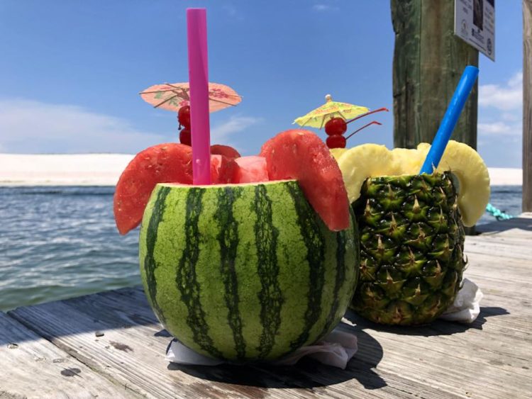 Drinks in a real pineapple and watermelon at Fishheads in Harborwalk Village
