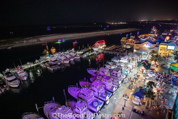 Destin Harbor with fireworks cruise boats coming back to HArborwalk