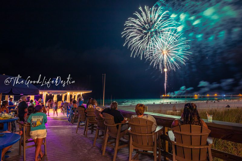 People watching the fireworks on Okaloosa Island from a beach bar