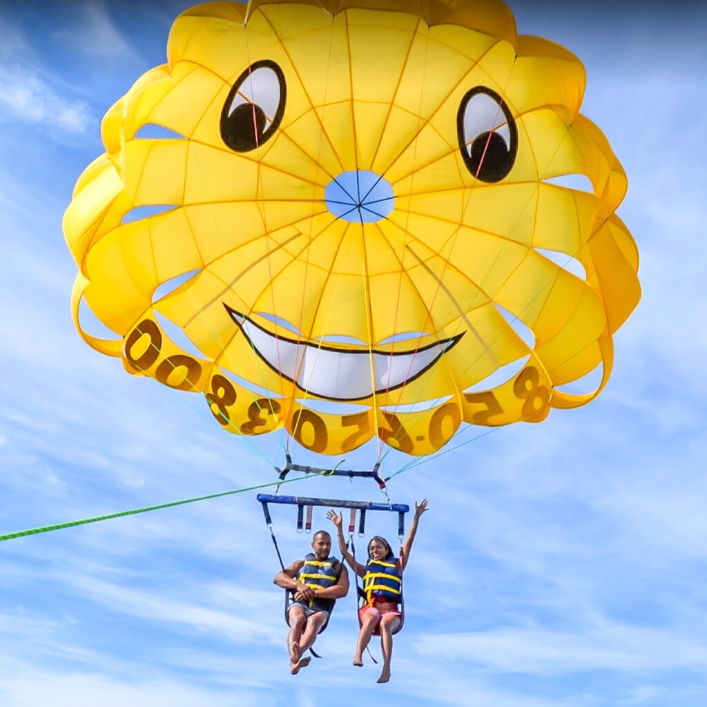 A couple on a yellow parachute Parasailing in Destin Florida