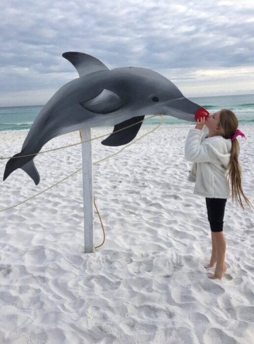 Photo of a kid with the dolphins at Back Porch