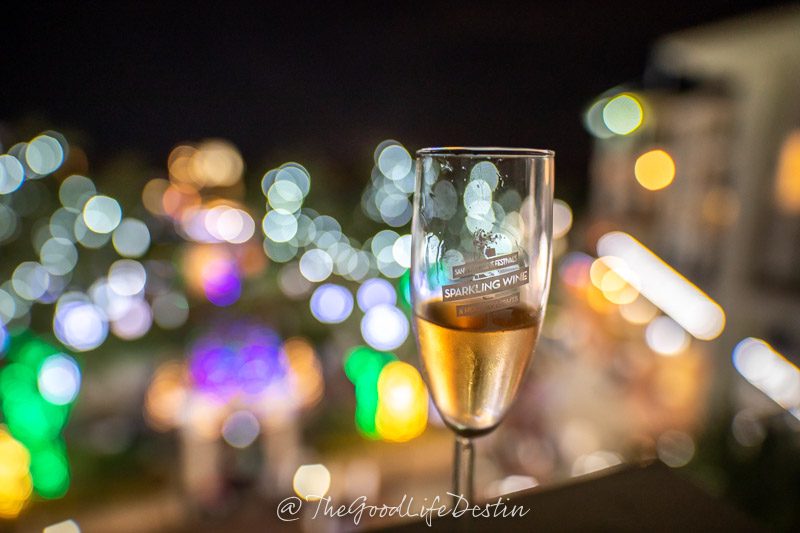 Wine glass in front of Christmas Lights at Baytowne Wharf in Sandestin