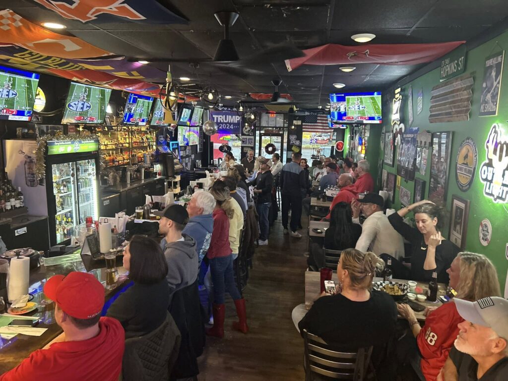 People at the bar and tables on a crowded night at CJs hangout and sports bar in Destin