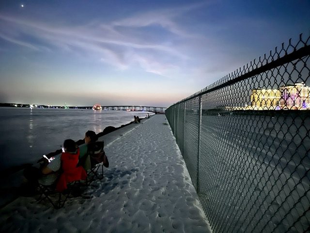 People waiting in chairs to watch the fireworks at Norriego Point in Destin