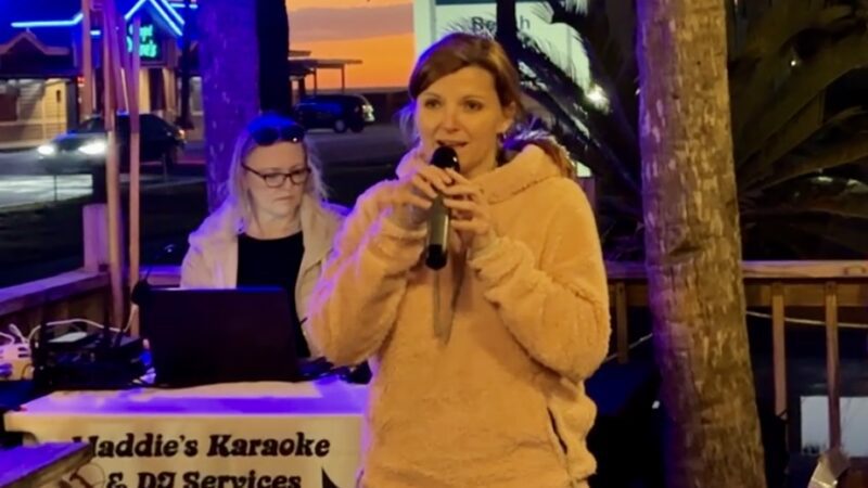 Singing karaoke at Kenny Ds in Miramar Beach