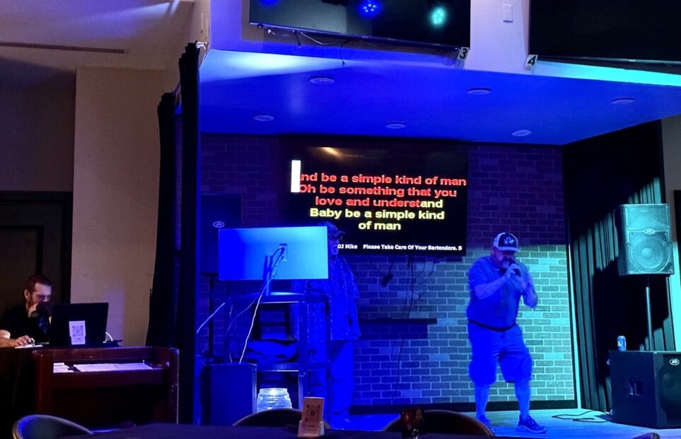 People singing karaoke on the stage at the Palms in Destin, Florida