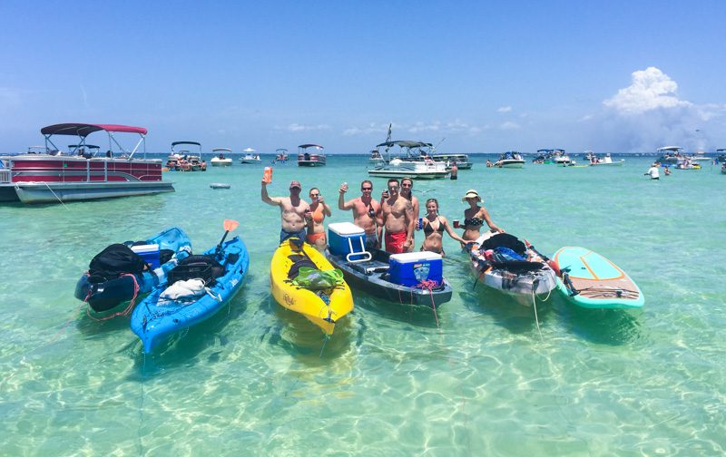 A group of kayakers and paddle boarders at Crab Island