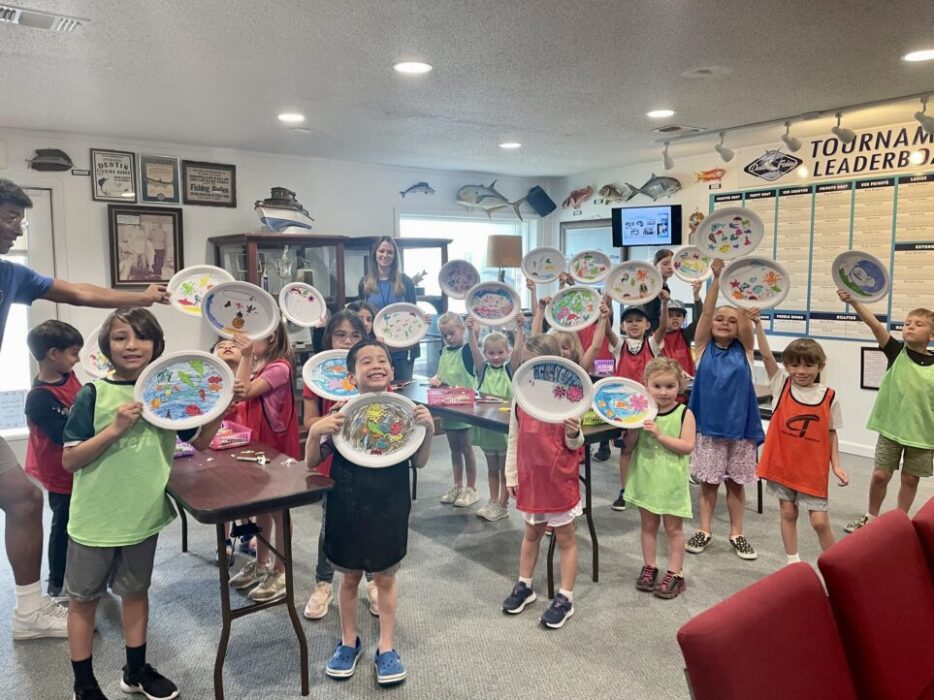 Kids holding up artwork at one of the spring break events at the Destin History Museum