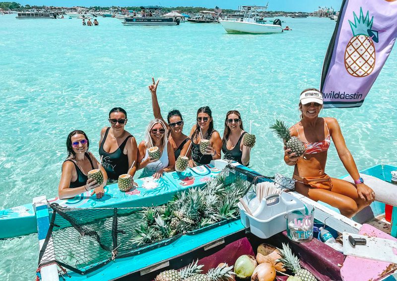 Wild Coconuts boat serving fresh pineapples in Destin at Crab Island