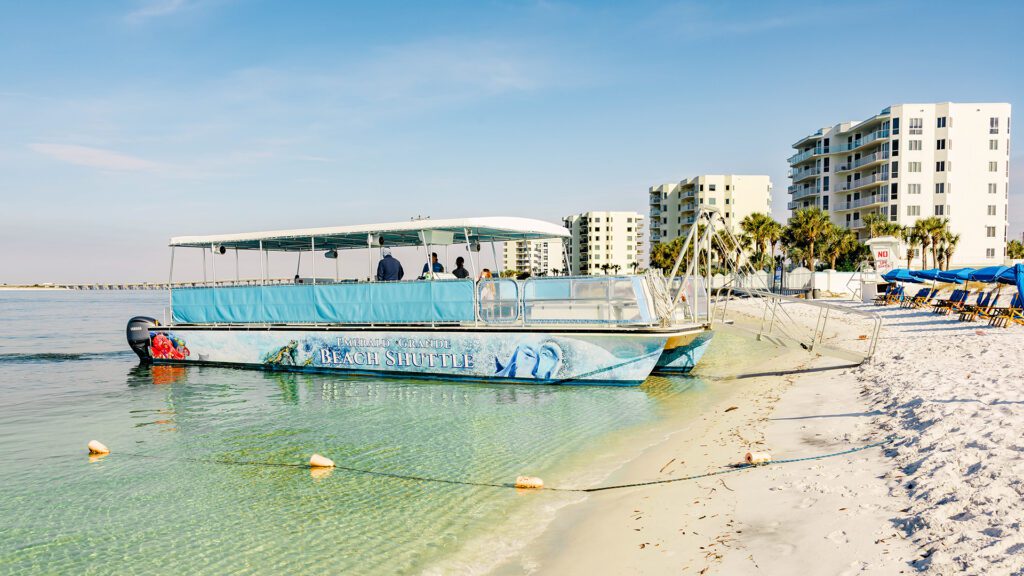 Emerald Grande beach shuttle boat parked at the O'Steen Beach shoreline
