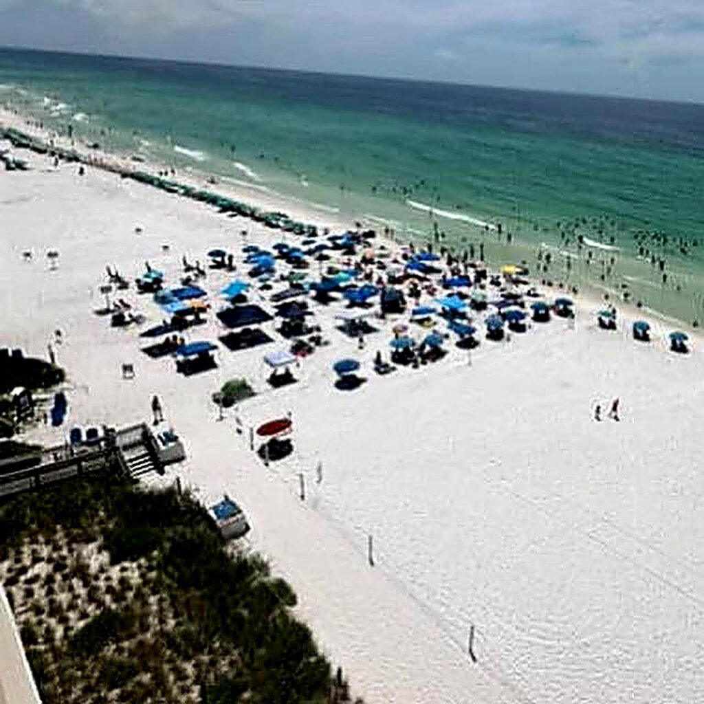Public Beach area showing people crammed into a roped off area between private beaches