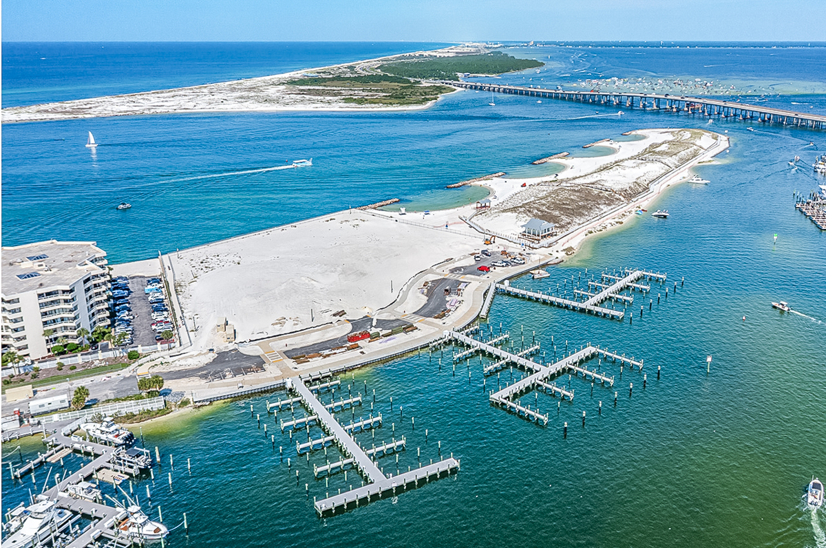 Aerial view of the existing large-boat docks at Norriego Point in Destin, Florida, with undeveloped sandy land and the completed park visible nearby.
