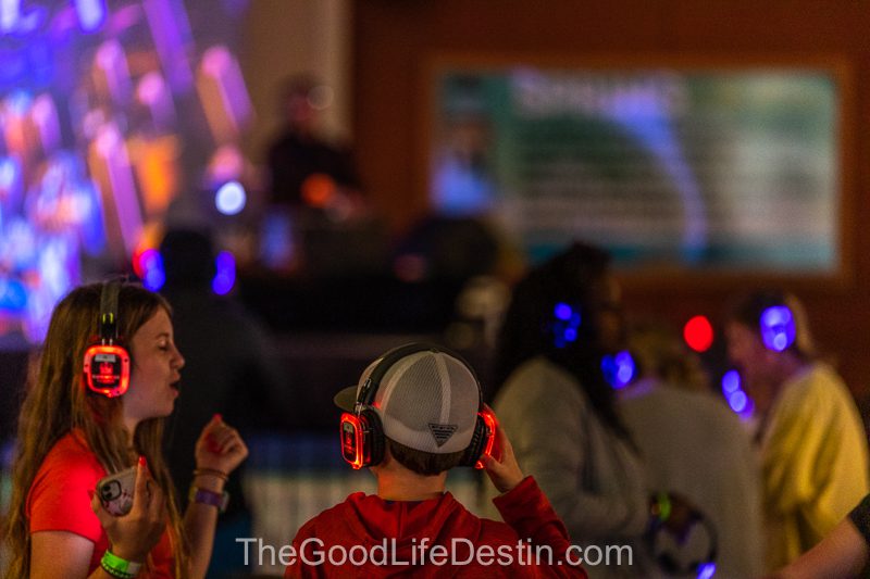 Familes and friends enjoying dancing with silent disco headphones at Harborwalk Village