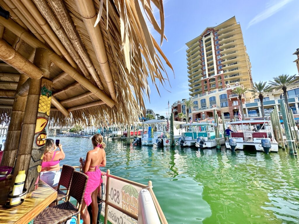 Destin Tiki Boat cruising through Destin Harbor