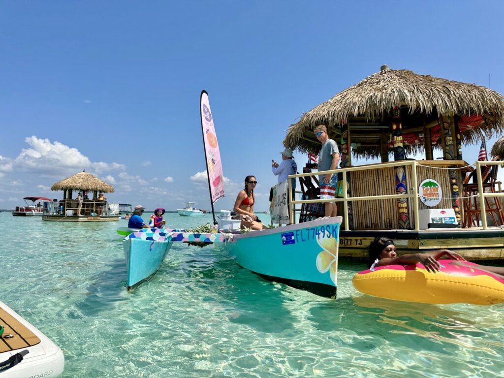 Clear water at Crab Island with a tiki boat
