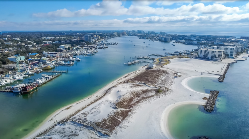 aerial image of Norriego Point sits at the very end of Gulf Shore Drive on Holiday Isle, the narrow stretch of land between Destin Harbor and the Gulf of Mexico at the East Pass, and right now it’s one of the most beautiful and peaceful places in Destin.
