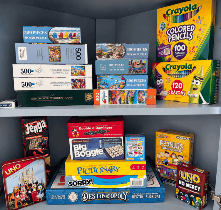 Cabinet organized with board games, puzzles and Crayola colored pencils
